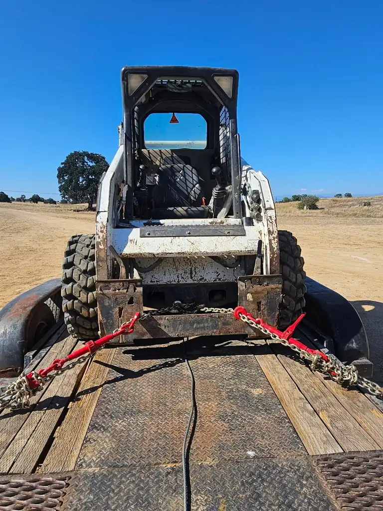 Superior Hauling Bobcat skid steer loaded on the trailer, ready to haul a job in Madera, CA