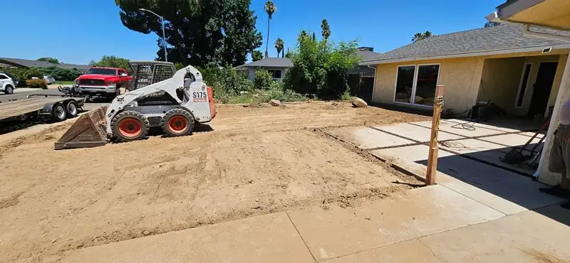Bobcat grading and leveling a residential backyard in Madera, CA