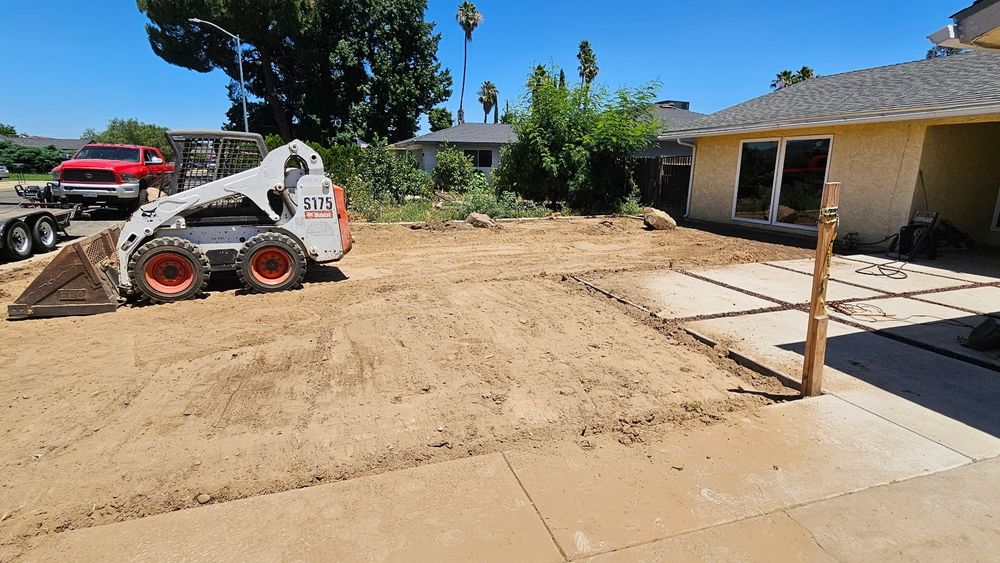 Superior Hauling Bobcat grading and leveling a backyard in the Central Valley