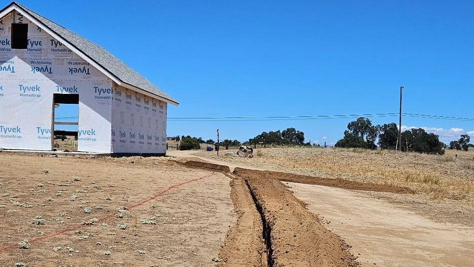 Superior Hauling Bobcat cutting a trench for new construction in the Central Valley